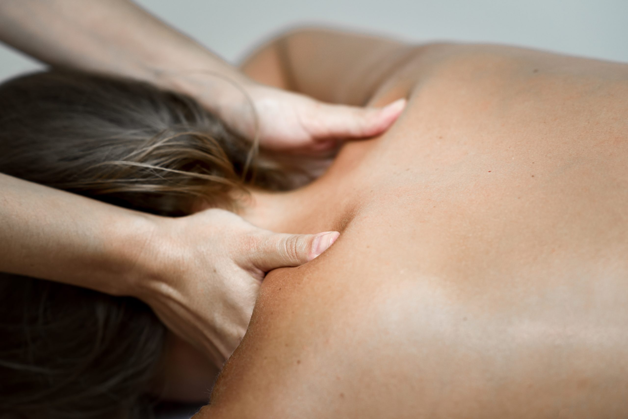 Young woman receiving a back massage in a spa center